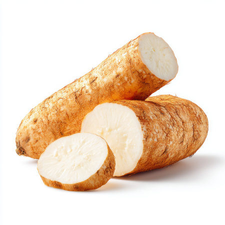 This image features a fresh raw tuber, sliced and whole, highlighting its creamy interior and rustic exterior. Ideal for healthy food concepts and recipes.の素材