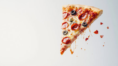 A vibrant slice of pepperoni pizza featuring gooey cheese and black olives, perfectly captured against a clean, light backdrop for an appetizing presentation.の素材