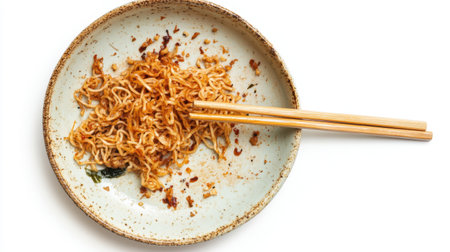 A dirty plate with leftover fried noodles and chopsticks, isolated on a white background, showcasing the remains of a delicious meal.の素材