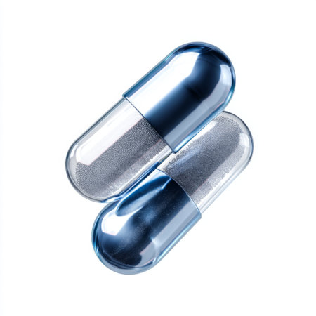 Isolated glossy blue and silver capsules arranged on a clean white background represent concepts of health, wellness, and pharmaceutical applications.の素材