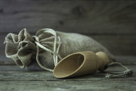 burlap sack and wooden scoop on a wooden の写真素材