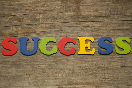 text success on a wooden backgroundの写真素材