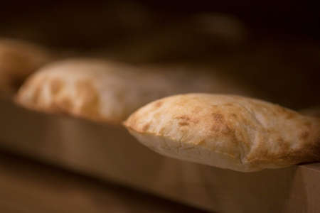 Freshly baked bread on a wooden board. Selective focus.