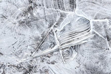 Pieces of ice in nature. Chunks of cracked ice closeup. Broken ice on the lake. Pieces of ice close...