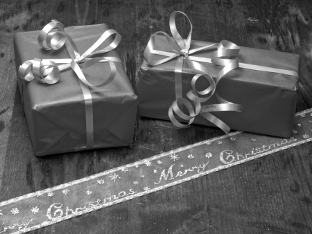 Christmas decoration, gifts with ribbons on a wooden background の写真素材