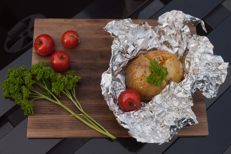 Jacked potato with garlic butter parsley and baconの写真素材