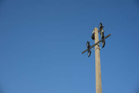 Spotlight on electricity pole against blue skyの写真素材