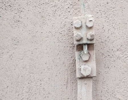 Painted screws on a stone wallの写真素材