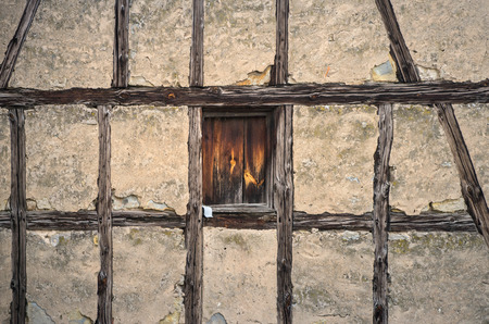 Half-timbered old house with an wooden windowの写真素材