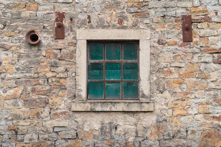 Old window on a stone wallの写真素材