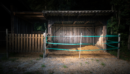 Horse shed with straw and fenceの写真素材