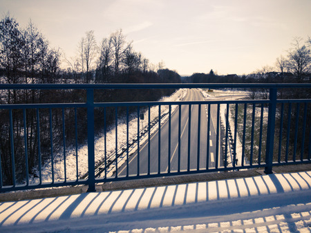 Rural view to a pedestrian walkway bridge and to the highwayの写真素材