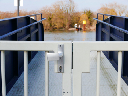 Closed door in front of a swimming moored buoyの写真素材