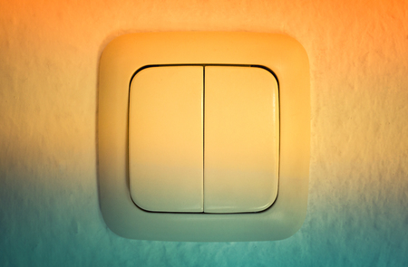 Light switch closeup with yellow green gradient over it