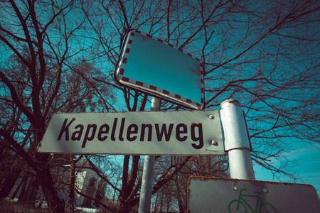 German street sign to the chapel way in front of a treeの写真素材