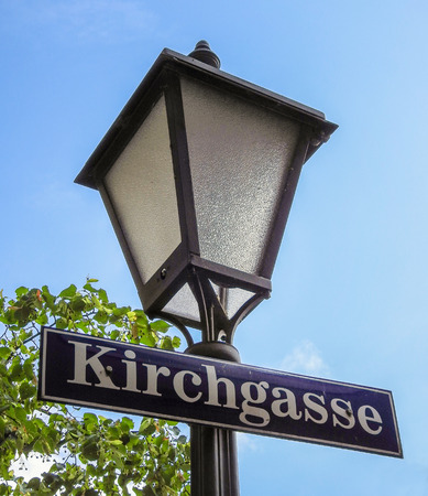Metal iron street lamp with the German street sign KIRCHGASSE on itの写真素材