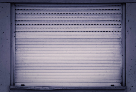 Old used and closed shutter backgroundの写真素材
