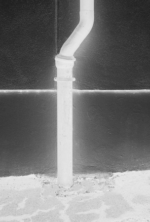 Surreal white gutter in front of a black wall - inverted colors give a fairytale like effect to this imageの写真素材