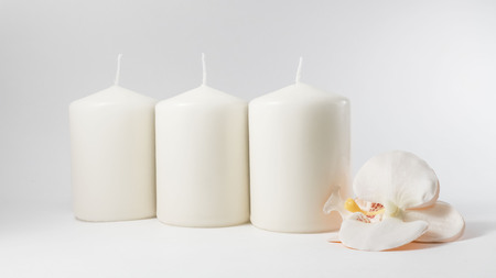 Candles and orchid flower on the whiteの写真素材