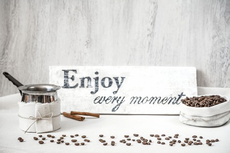 Roasted coffee beans and pitcher for making coffeeの写真素材
