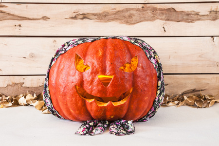 Pumpkin in colorful  bandana on a wooden backgroundの写真素材