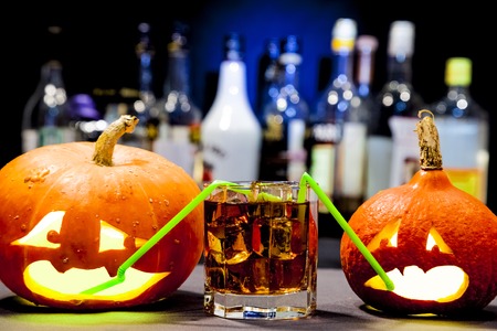 Jack O' Lantern. Halloween party. Funny Pumpkin with a cocktailの写真素材