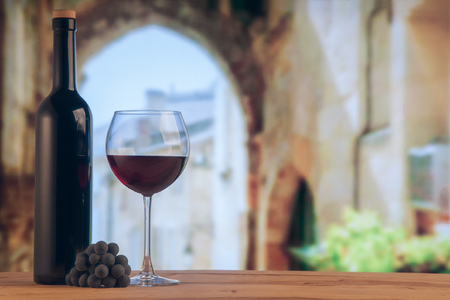 Red wine glass and red wine bottle on the winery backgroung.の写真素材