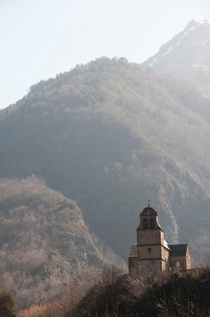 A lone chapel surrounded by moutainsの写真素材