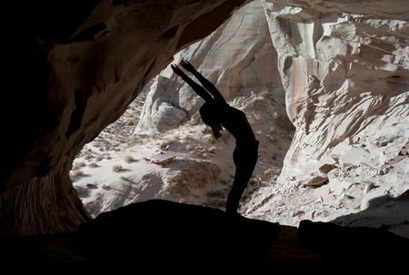 Woman exercising in Ulrike's Cave, Amangiri, Canyon Point, Utah, USAの写真素材