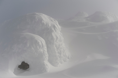 Snow covered mountain surrounded with fog, Whistler, British Columbia, Canada
