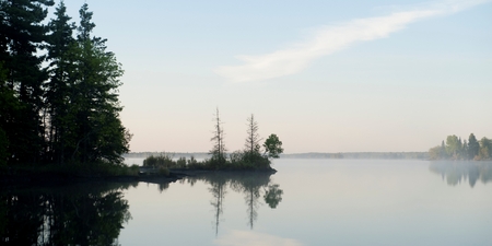 Reflection of trees in water, Lake of the Woods, Ontario, Canadaの写真素材