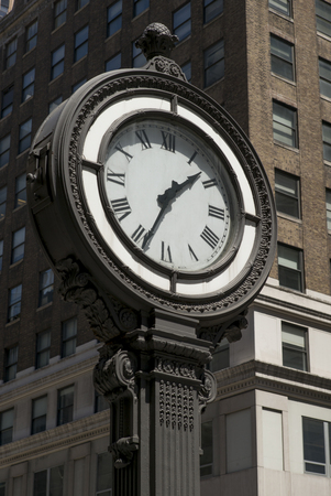 Low angle view of a street clock, Manhattan, New York City, New York State, USAの写真素材