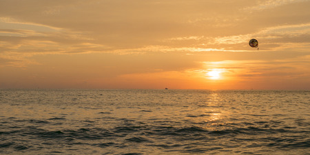 View parasailing over the ocean at sunset, Zihuatanejo, Guerrero, Mexicoの写真素材