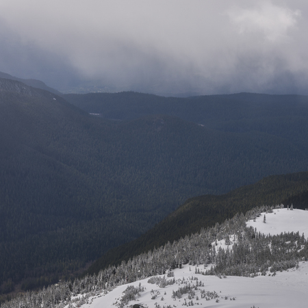 View of snow covered valley with mountains in winter, Whistler Mountain, British Columbia, Canada