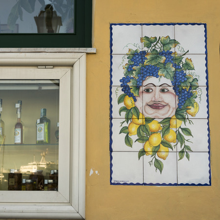 Tiled mural on wall by wine shop window, Casamicciola Terme, Campania, Italyのeditorial素材