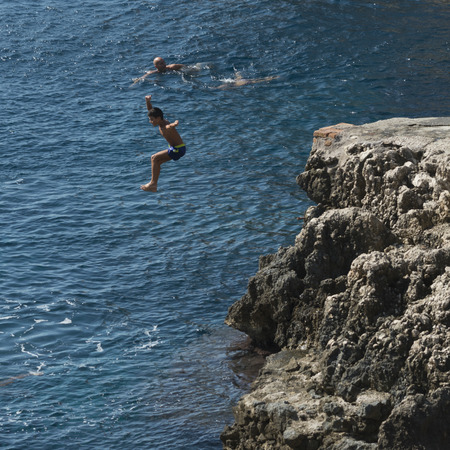 Boy jumping into the sea, Anacapri, Capri, Campania, Italyの写真素材