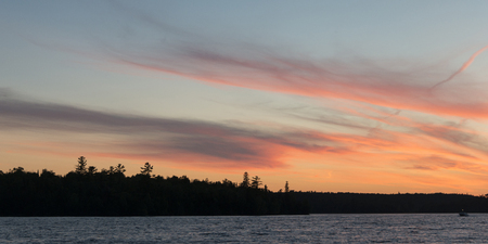 Silhouette of trees at the lakeside, Kenora, Lake of The Woods, Ontario, Canadaの写真素材