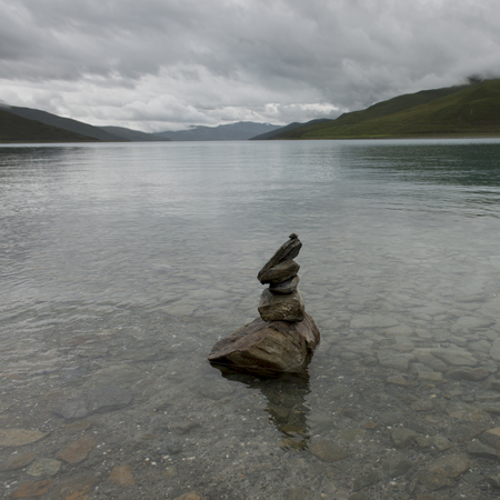 Stack of stones in the Yamdrok Lake, Nagarze, Shannan, Tibet, Chinaの写真素材