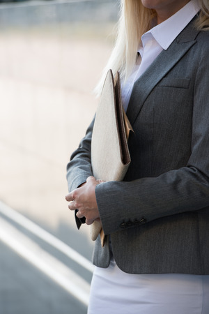 Unrecognizable business woman holding reports. Copy spaceの写真素材