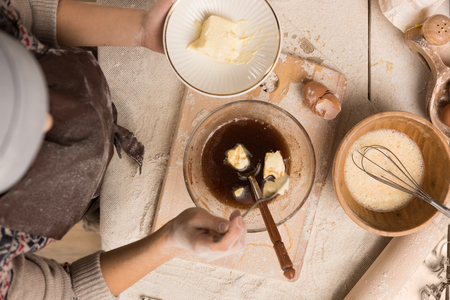Woman baking Christmas cookies in her kitchen. Top view