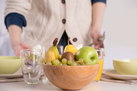 Human hands preparing table for lunchの写真素材