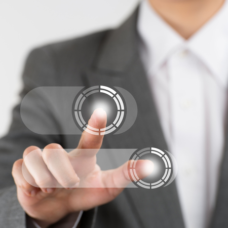 Business woman pushing virtual button on touch screenの写真素材