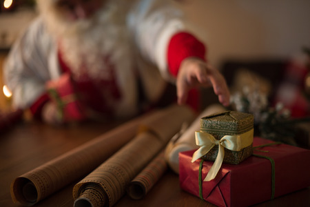 Santa Claus at Home wrapping christmas giftsの写真素材