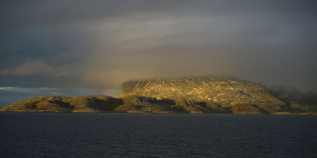 View of sea and mountain against cloudy sky, Nordland, Norwayの写真素材