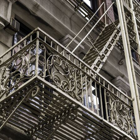 Low angle view of fire escape on apartment building, Lower Manhattan, New York City, New York State,...