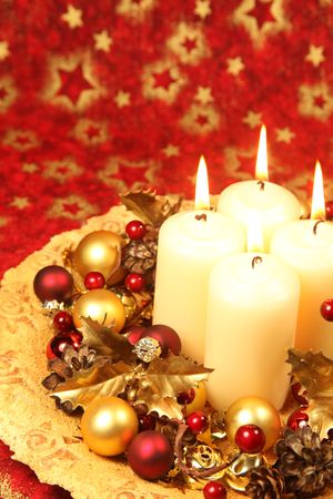 Christmas decoration with four candles on red Christmas background. Shallow DOF, copy spaceの写真素材