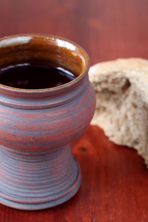 Communion chalice with red wine and bread. Shallow dof, copy spaceの写真素材