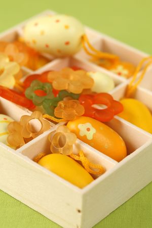 Yellow Easter eggs and little glass flowers in a boxの写真素材
