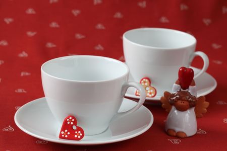 Empty cups with hearts and angelの写真素材
