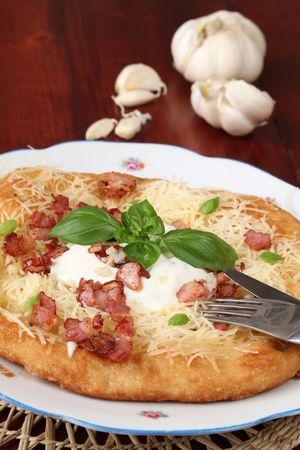 Langos, traditional Hungarian pancake with cheese, bacon, and garlicの写真素材